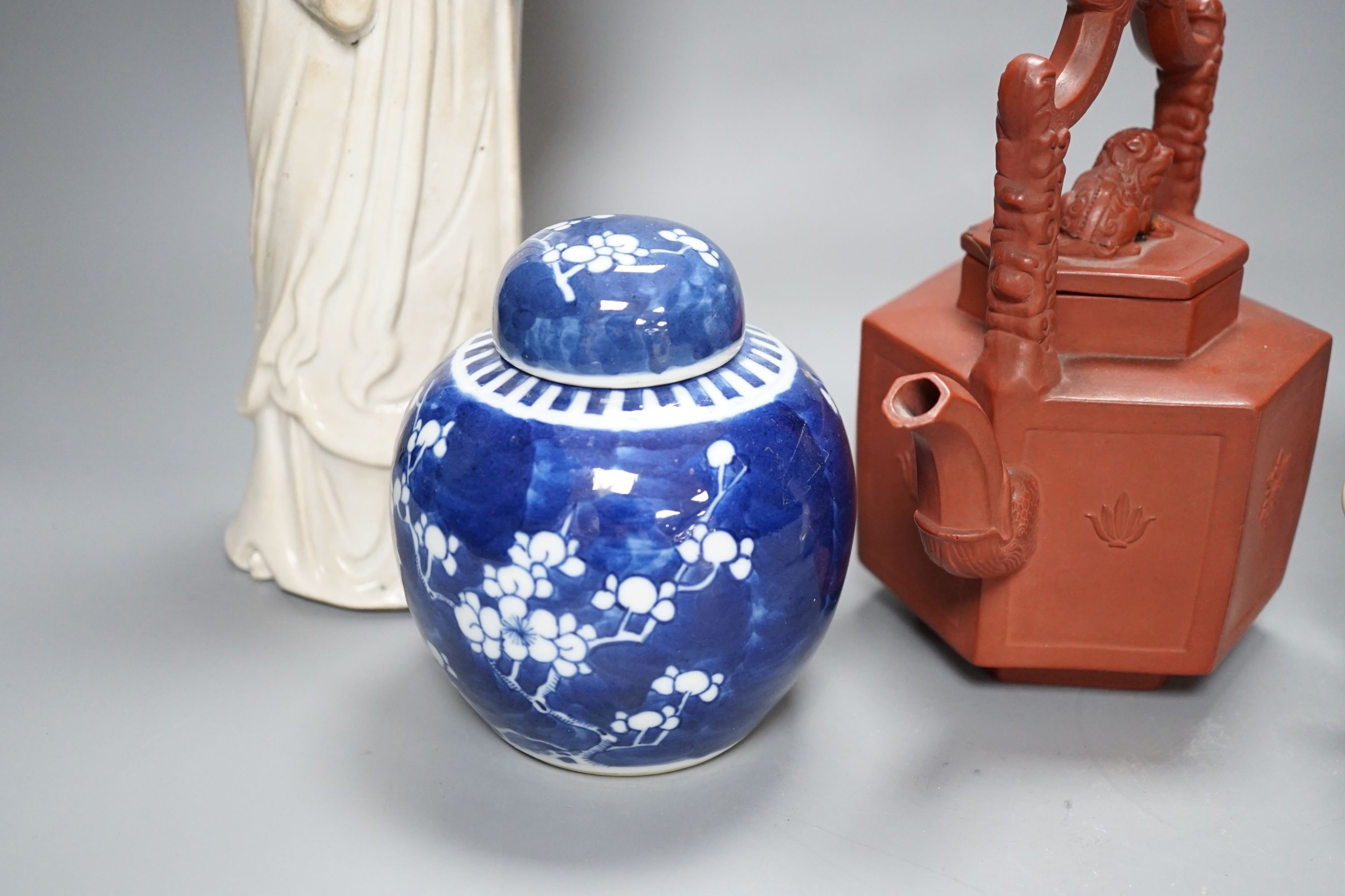 A Chinese blanc de chin figure of a lady with a bird, 37cm, together with a famille rose teapot, a yixing style teapot, blue and white jar and cover and a pale celadon ground ‘ox head’ libation cup